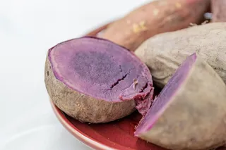 Purple potato cut in half, showing purple inside