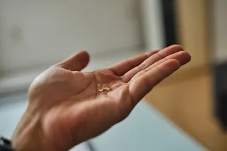 Vitamin D supplement in a person's hand