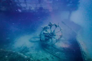 Shipwreck underwater, showing the helm