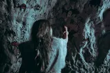 primitive person drawing in a cave 