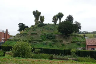 Marlborough mound with lush green grass and green trees growing on it 
