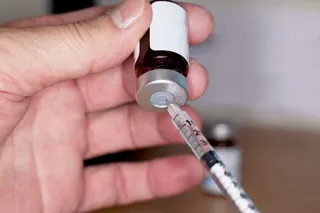 A syringe draws testosterone replacement therapy medication from a vial as the FDA considers label changes for TRT products.