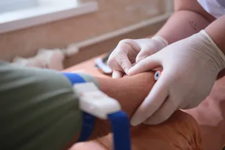doctor drawing blood from a patient 