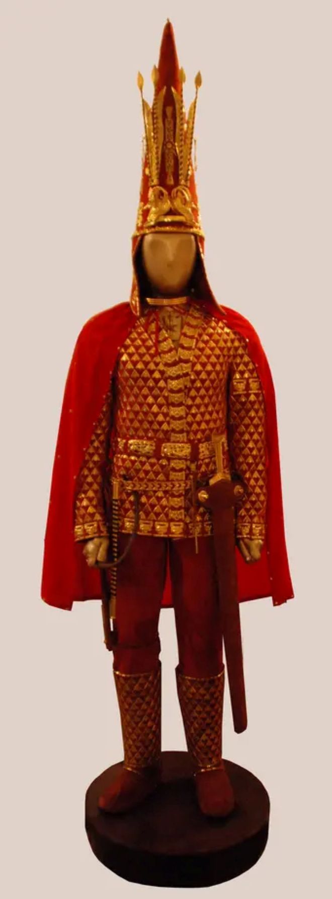 Golden man statue with red jacket and boots 