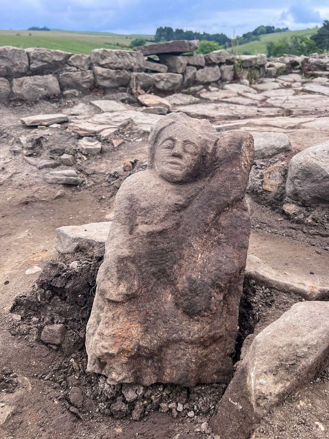 Genius relief statue at dig site 