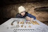a young Ph.D. candidate looking at megafauna fossils 
