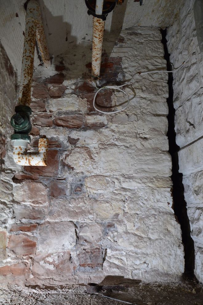 Exposed medieval stone wall that once supported a bridge to Chester Castle beneath Chester Crown Court.