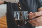 Person pouring a cup of coffee