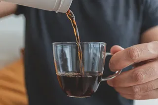 Person pouring a cup of coffee