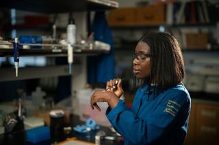 A researcher tests a zinc oxide mineral sunscreen formulation on her hand in a laboratory.