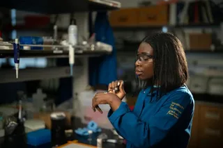 A researcher tests a zinc oxide mineral sunscreen formulation on her hand in a laboratory.