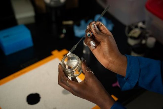 A researcher mixes an experimental zinc oxide mineral sunscreen formulation in a lab.