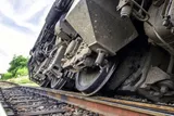 close up of train wheels on a derailed train 