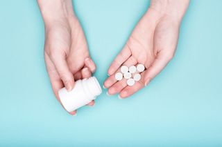 Oral antihistamine pill in someone's hands