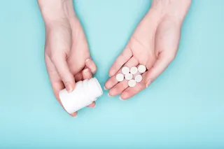 Oral antihistamine pill in someone's hands