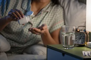 Person takes melatonin pills before bed to fall asleep