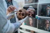 Neanderthal babies. Two experts reviewing an ancient skull 