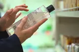 Person reads a cosmetic product label