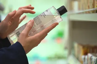 Person reads a cosmetic product label