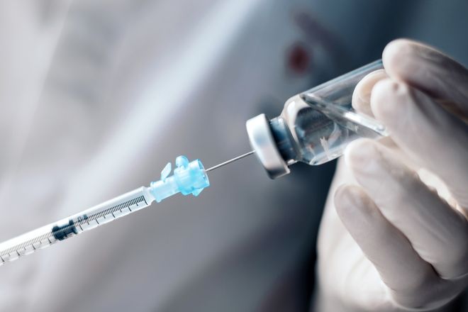 Medical expert holding a vaccine