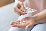 Person with their round of antibiotics in their hand 