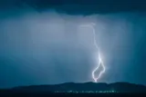 Bolt of lightning striking over a small town