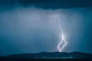 Bolt of lightning striking over a small town