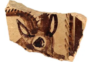 piece of pottery with an animal face