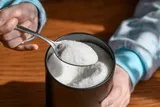 xylitol being scooped with a spoon