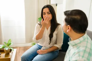 Someone smelling a bad odor in someone else's house