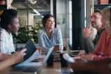 Group of employees around a meeting table 