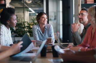 Group of employees around a meeting table