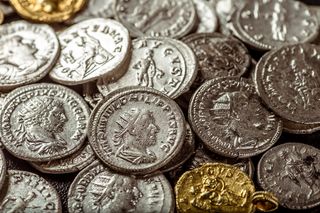 Overlapping silver- and gold-colored Roman coins.