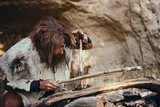 ancient human using tools to make fire 