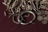various silver pieces on a red cloth 