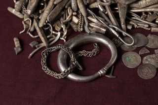various silver pieces on a red cloth 