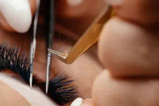 Person getting eyelash extensions, close-up