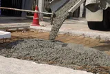 Concrete poured over steel reinforcement bars at a construction site, illustrating research into using treated human poop in concrete.