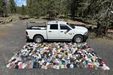 rows and rows of hats lost in Yellowstone national park next to a park truck 