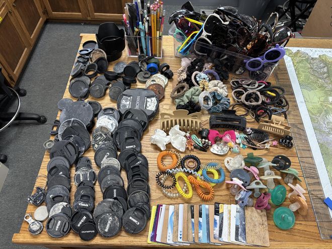 Lens caps, hair ties, pencils, and hotel keys Lens caps, hair ties, pencils, and hotel keys