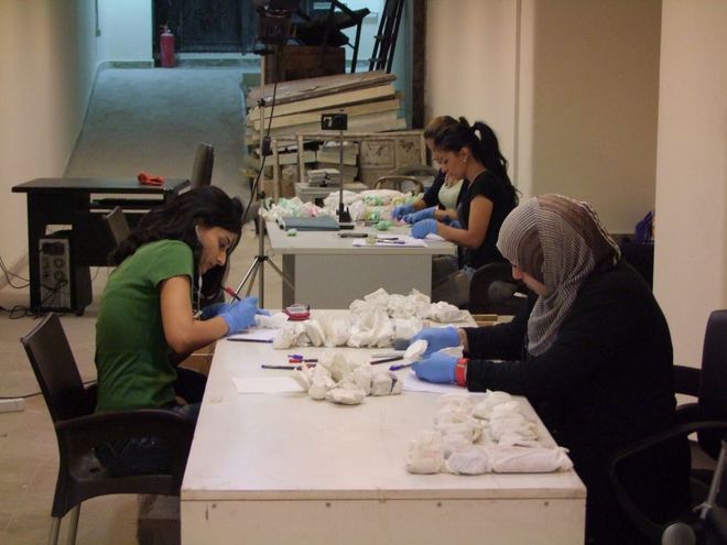 museum workers documenting and packing museum items museum workers documenting and packing museum items
