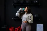 woman drinking a creatine shake 