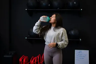 woman drinking a creatine shake