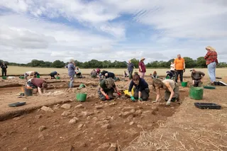 Archeologists digging up ancient Roman villa wall