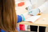 Woman getting a blood test possibly for breast cancer