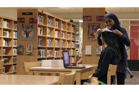 Kashfia in her natural environment, fitting brain sensors on a test subject in her school library. (Credit: Univision)