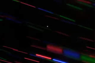 Earth's new minimoon, catalogued as 2020 CD3, shows up as a dot in this image from the Gemini Observatory. Tracking the object as it moved turned surrounding stars into colored streaks. (Credit: Gemini/OIR/AURA/G. Fedorets)