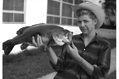 Young man with largemouth bass b&w